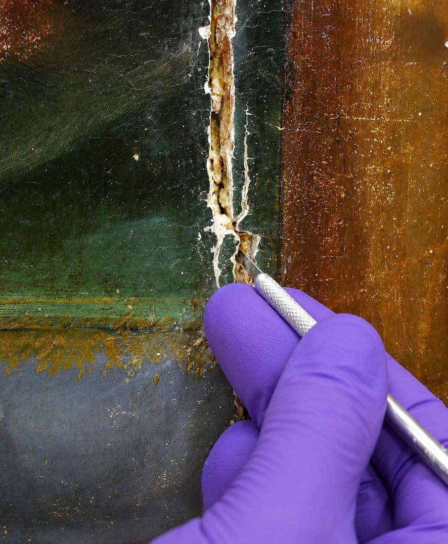 Reducing an old fill along a crack in an oil painting with a scalpel